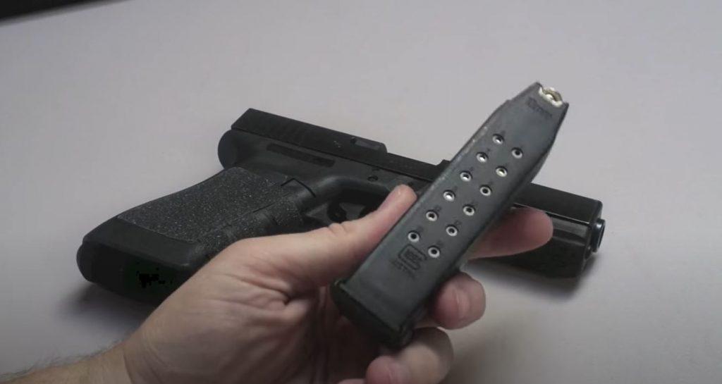 The Glock 20's magazine is a chunky double-stack stick.