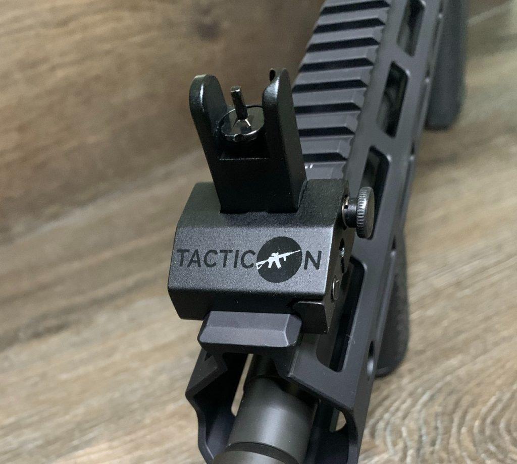 The front sight post is a little crude and pretty large. The large button (right) engages the sight. Again, its noticeably wider than the rail.
