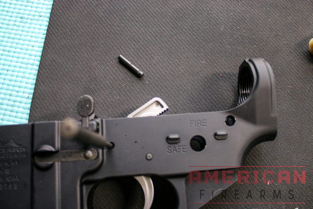 A pin punch can be used to hold the trigger assembly in place while you hammer in the lower trigger pin until it is flush.