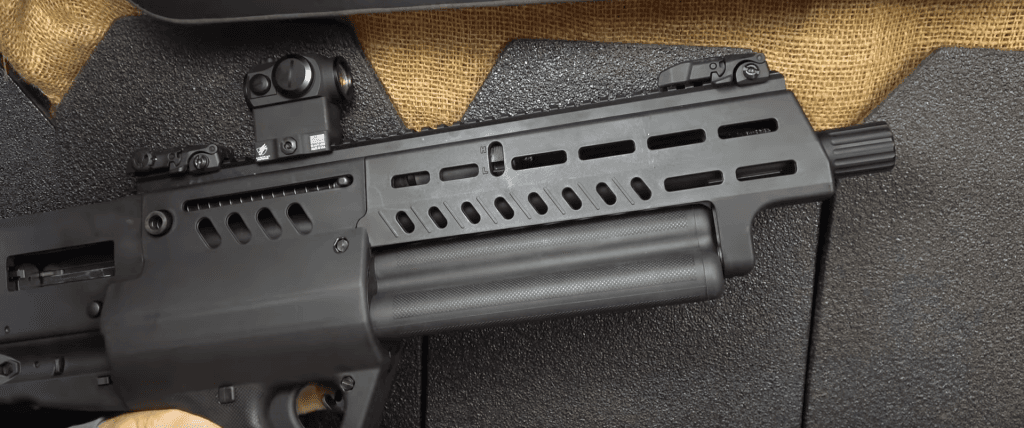 A full 18.5-inch barrel, M-Lok slots, & a swappable choke. Here you can see both the triple rotating tube magazines as well as the H/L selector for tuning the TS12 to either 3-inch or 2 3/4-inch shells.