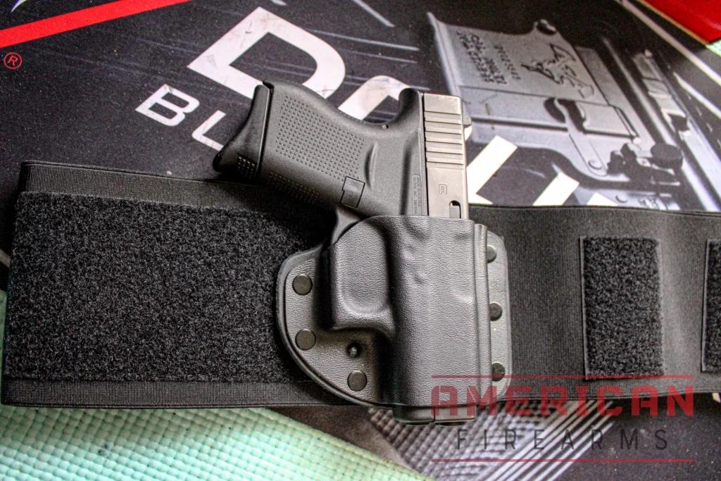 The Modular Belly Band pairs an integrated Kydex holster with a strap which wraps back over the firearm.