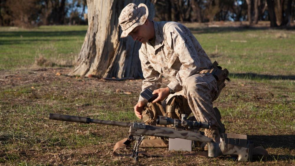 Fig. "Cpl. John Luze, a competitor with the Marine Corps Shooting Team, loads a magazine before a practice fire with his M40A5 sniper rifle at Puckpunyal Military Area in Victoria, Australia, May 7, 2016. The M40A5 is a bolt-action sniper rifle that the Marine Corps uses for long-range enemy engagements." (Photo/caption: Department of Defense)