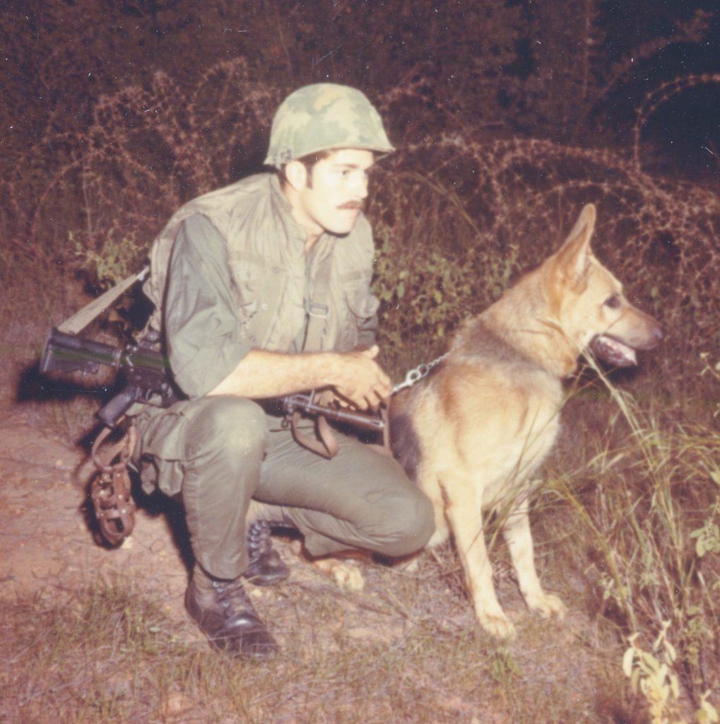 KE 42105 - USAF AIC Steve J Barris and his K-9 dog Prince of the 35th Security Police Squadron guard the base perimeter Phan Rang Air Base, Sout Vietnam. 1 Nov 1970. Photo by AIC Pet Pittas, USA