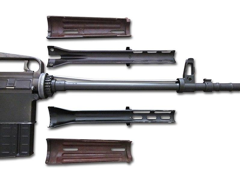 A disassembled AR-10 handguard displaying the gas system