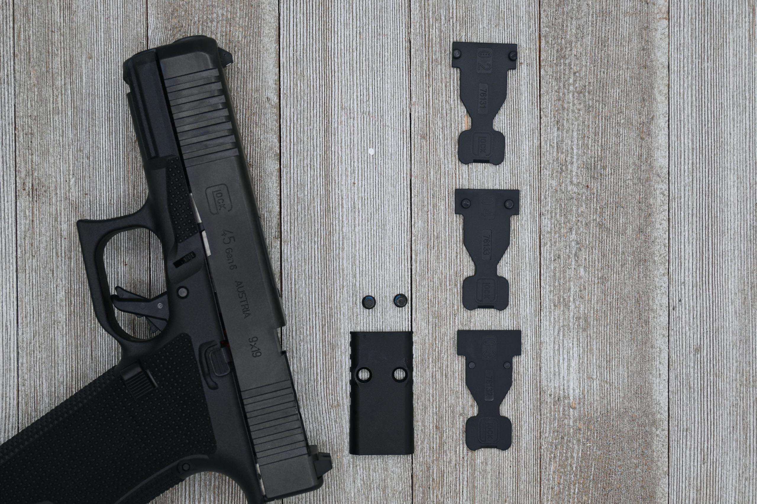 The three included ORS inserts — for RMR/Holosun, C-More, and DeltaPoint Pro/Defender footprints — sit next to the direct-milled slide cut they align with. These function more like screw-pattern locators than the traditional metal adapter plates of the MOS system.