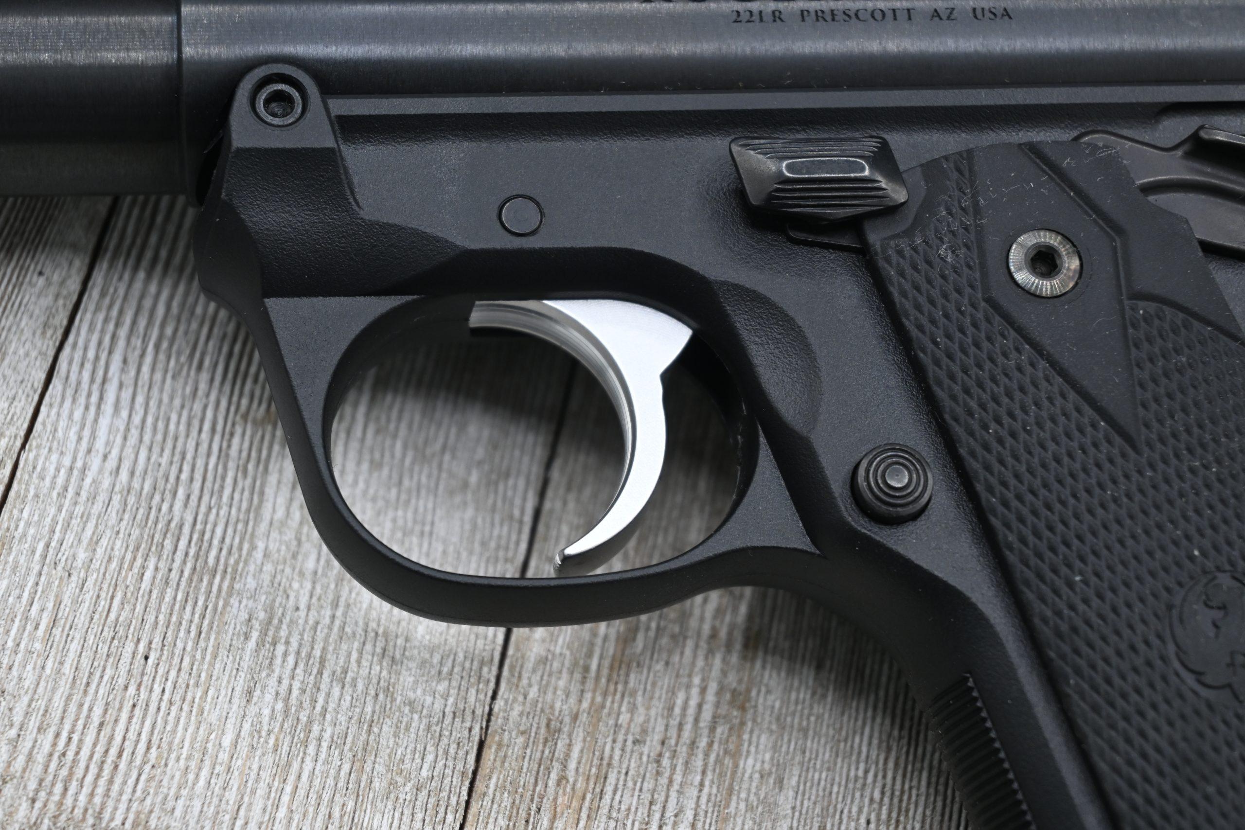 Mark IV 22/45 left-side controls closeup — mag release, safety, grip panel