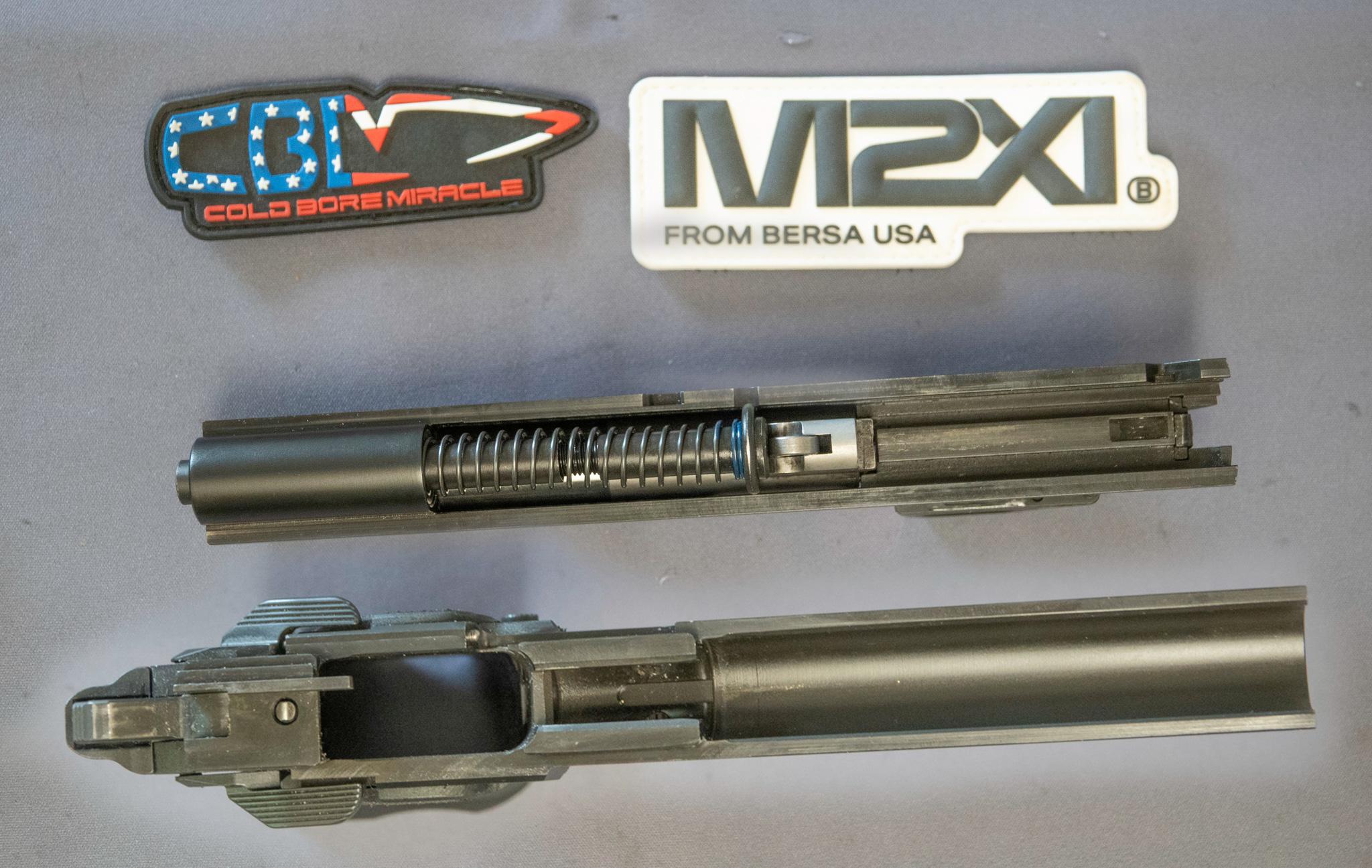 A closer look at the M2Xi's slide and barrel assembly, illustrating its bushing-less design and Wilson/Nowlin-style feed ramp.